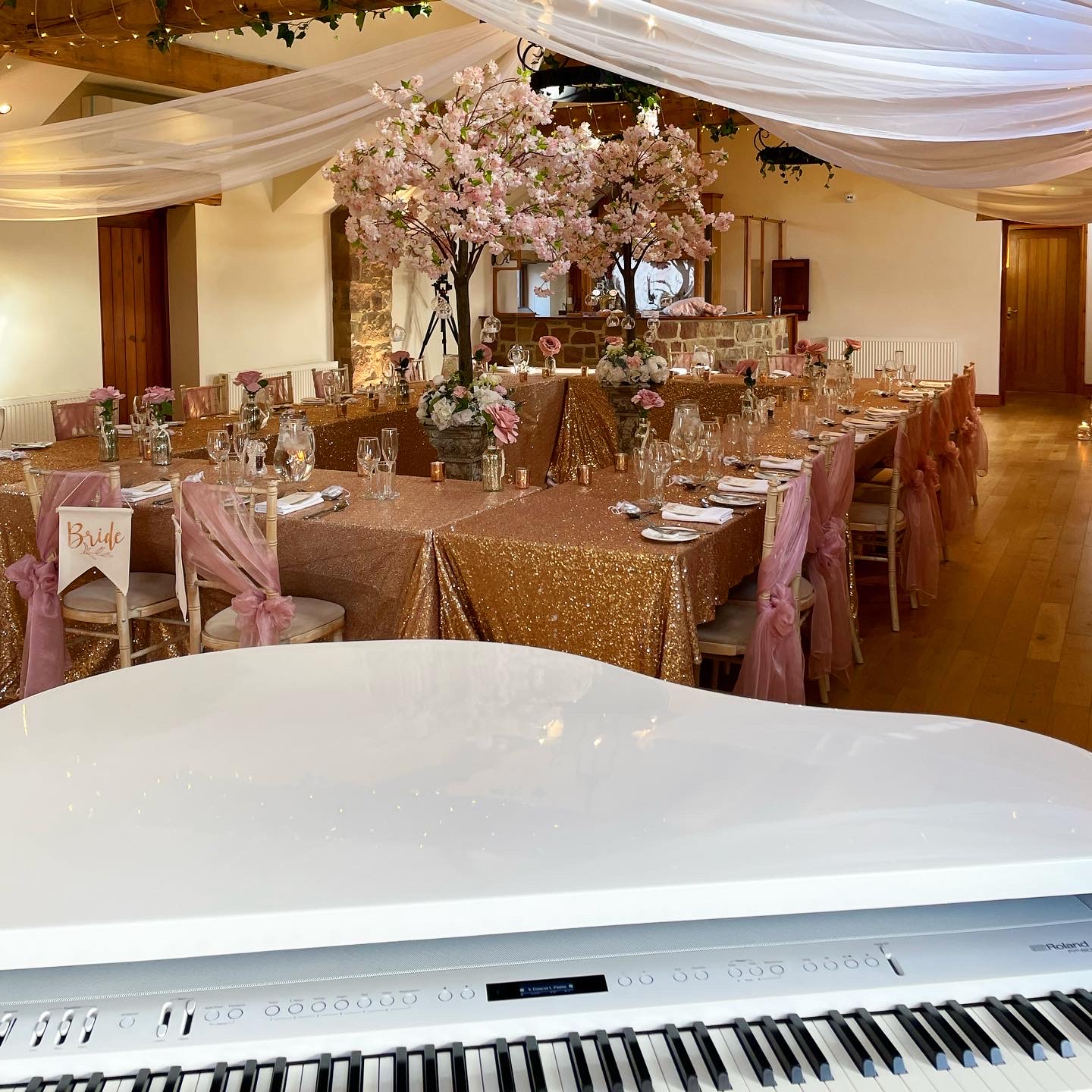 Wedding pianist Craig Smith's white baby grand piano set up ready for a Beeston Manor wedding breakfast