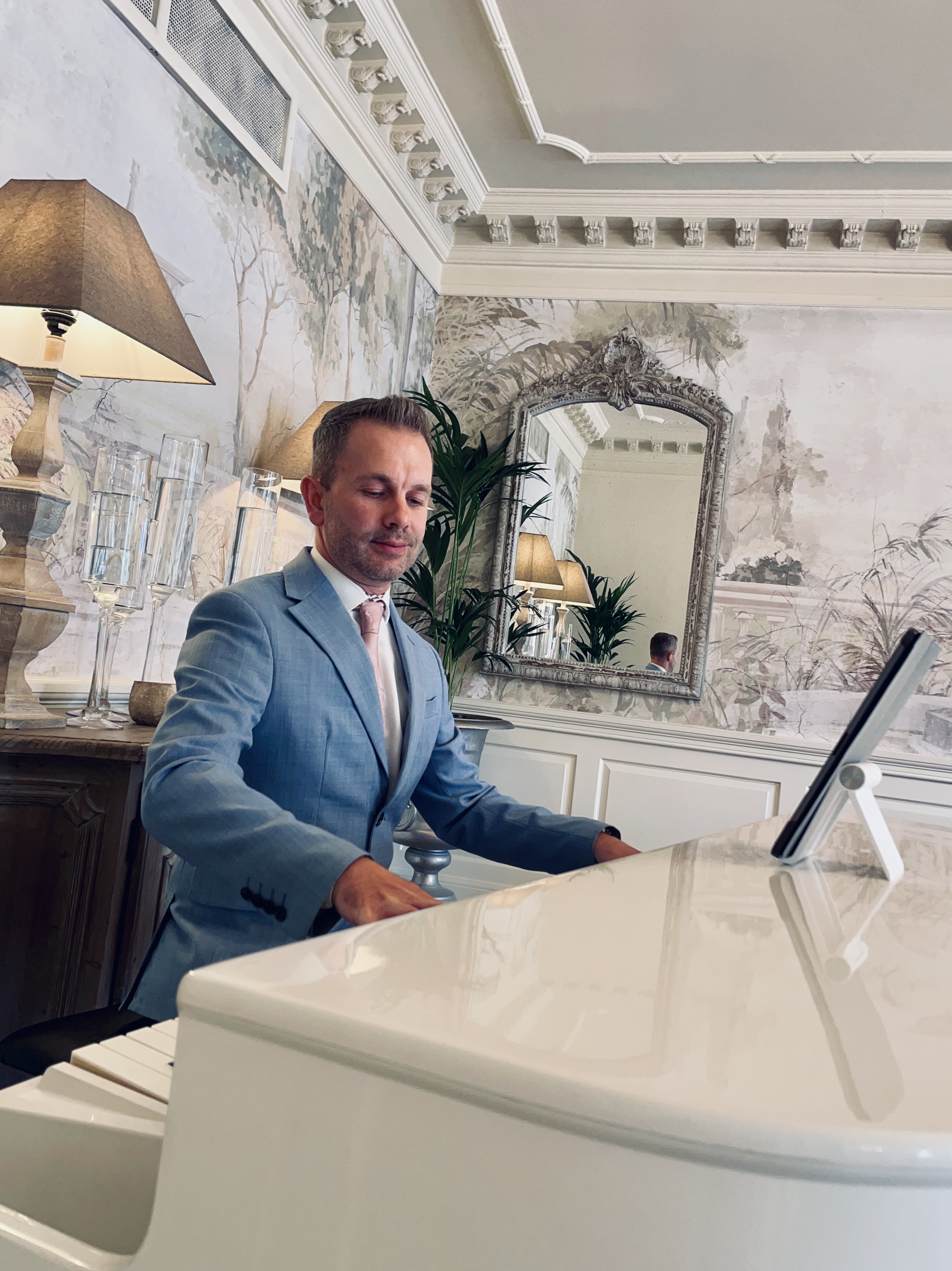 Eaves Hall wedding pianist Craig Smith plays piano during a wedding breakfast in the Dining Room.