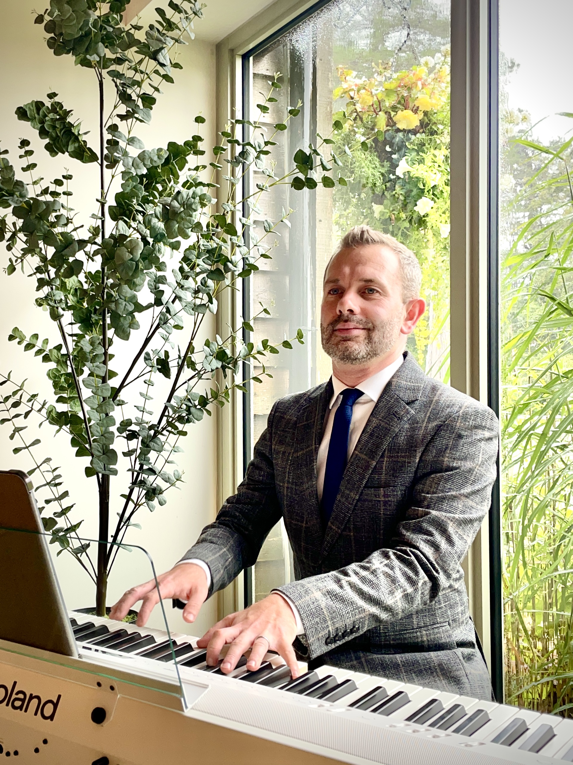 Craig Smith plays piano during a Hobbit Hill wedding ceremony.