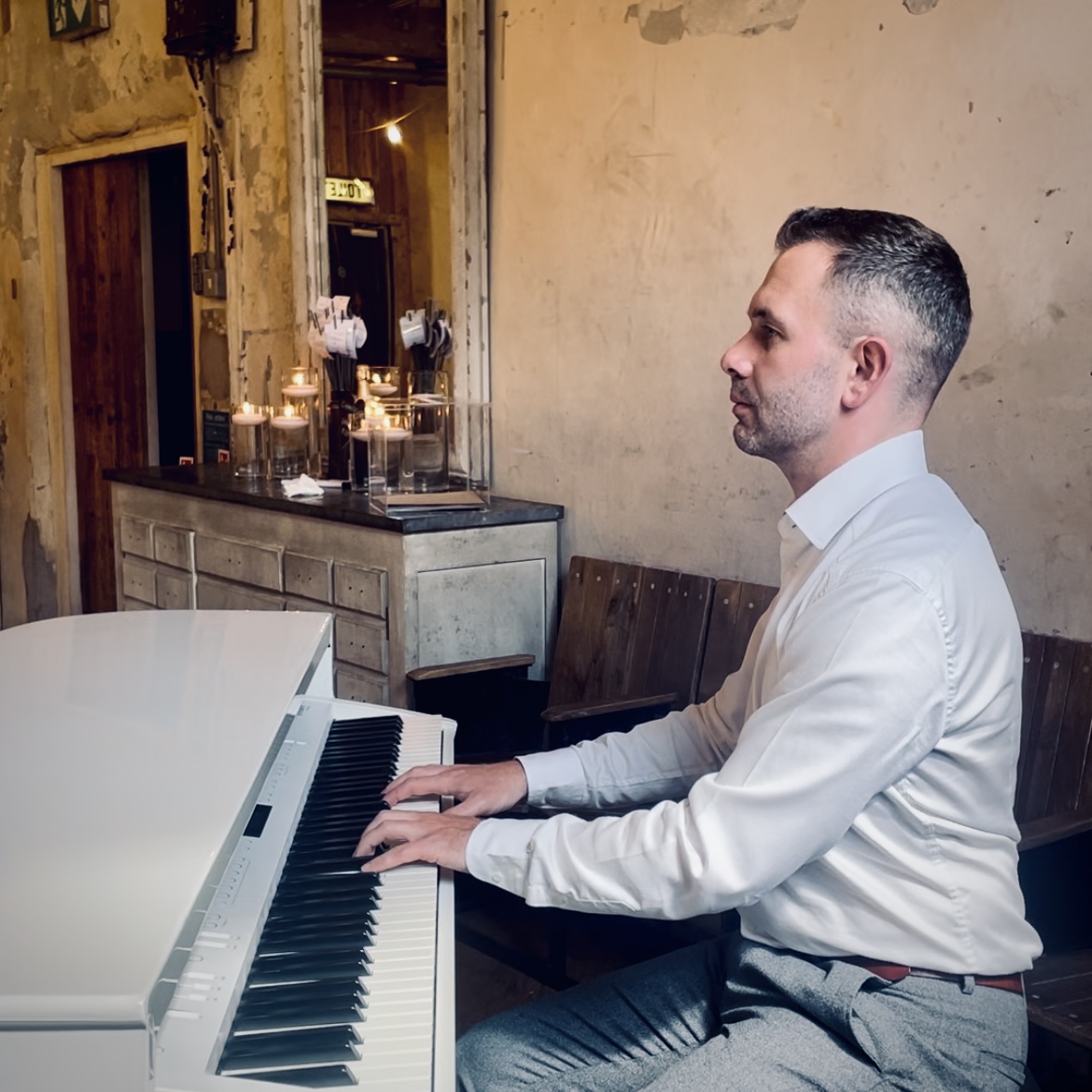Holmes Mill wedding pianist Craig Smith plays his white baby grand piano for a wedding reception