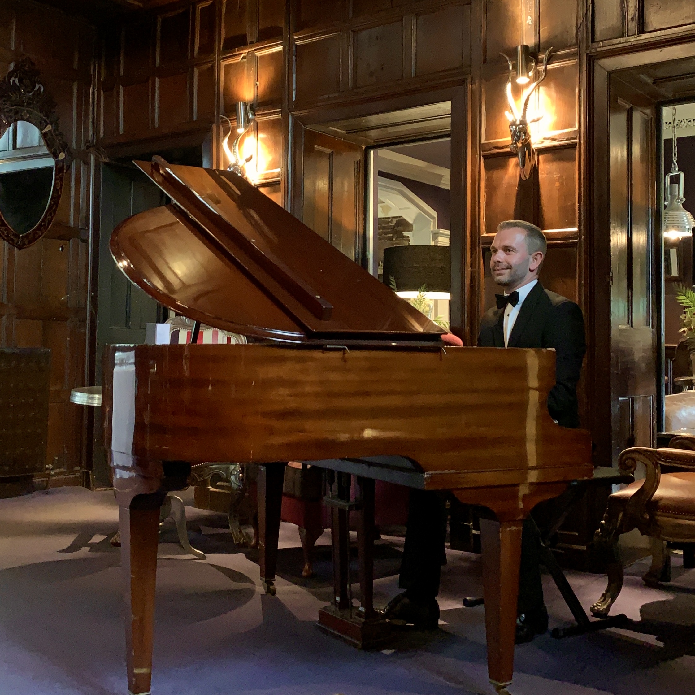 Wedding pianist Craig Smith plays Mitton Hall's grand piano in the wood-panneled Great Hall