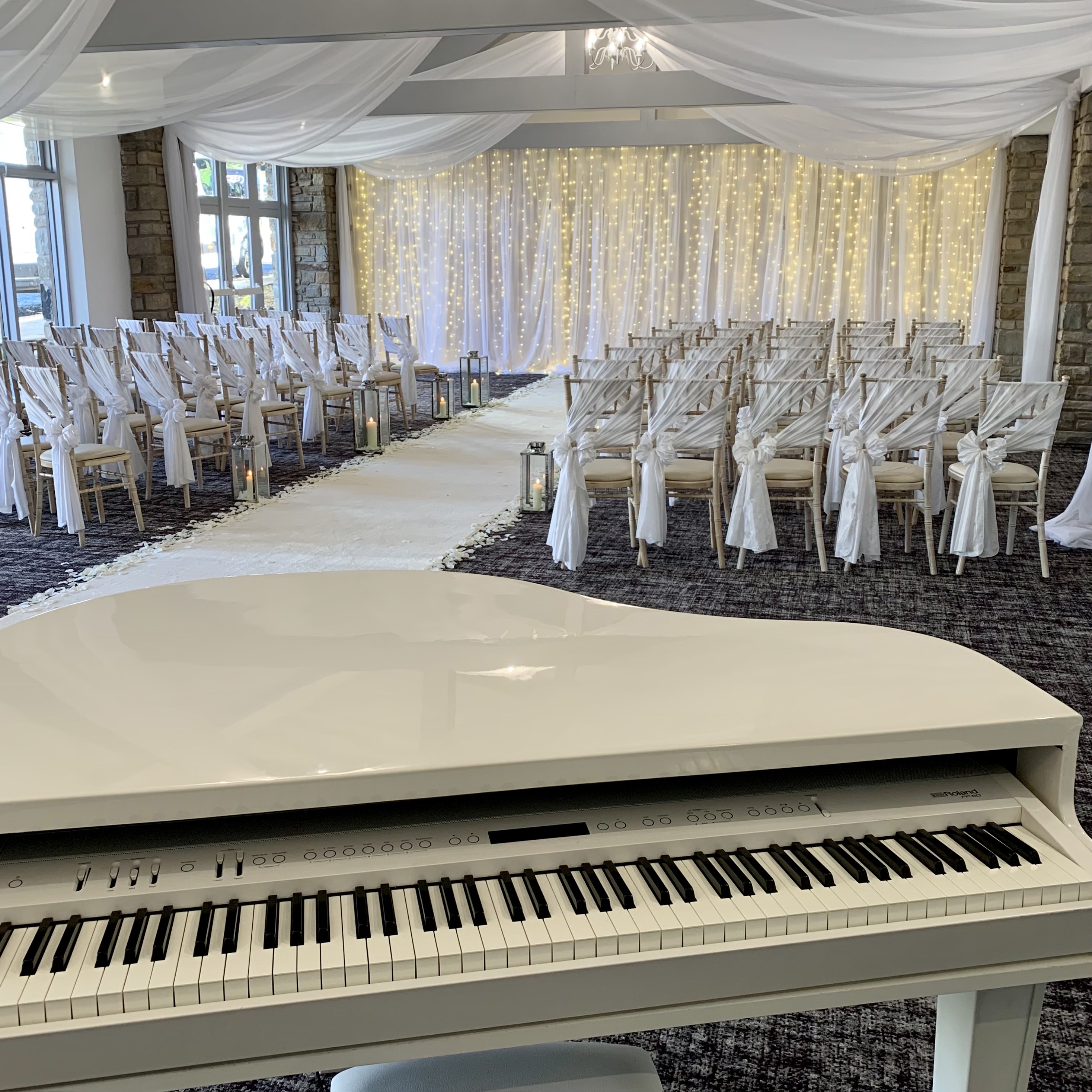 Mytton Fold wedding pianist Craig Smith's white piano ahead of a wedding ceremony