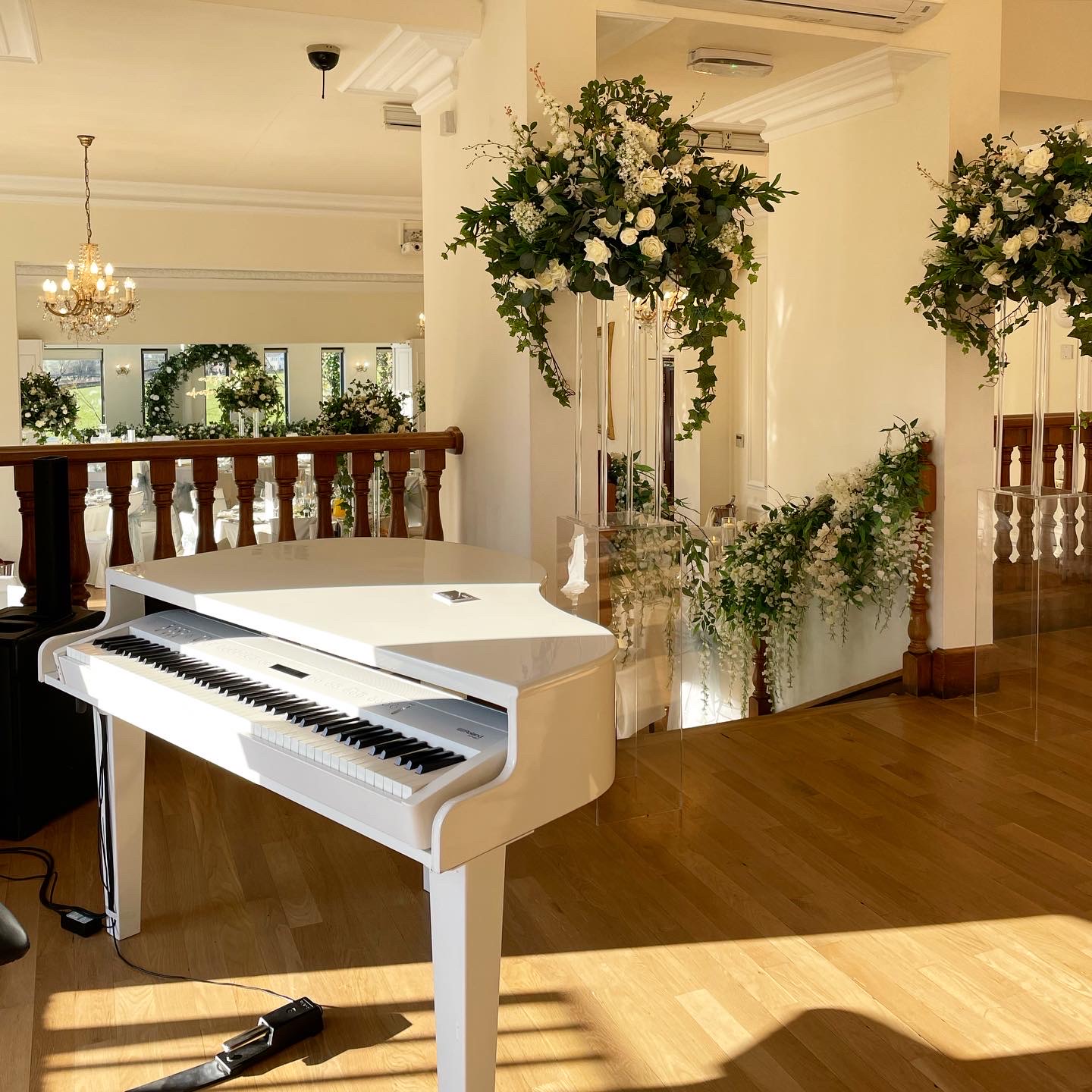 West Tower's recommended wedding pianist Craig Smith's white piano set up for a wedding breakfast in the Ballroom