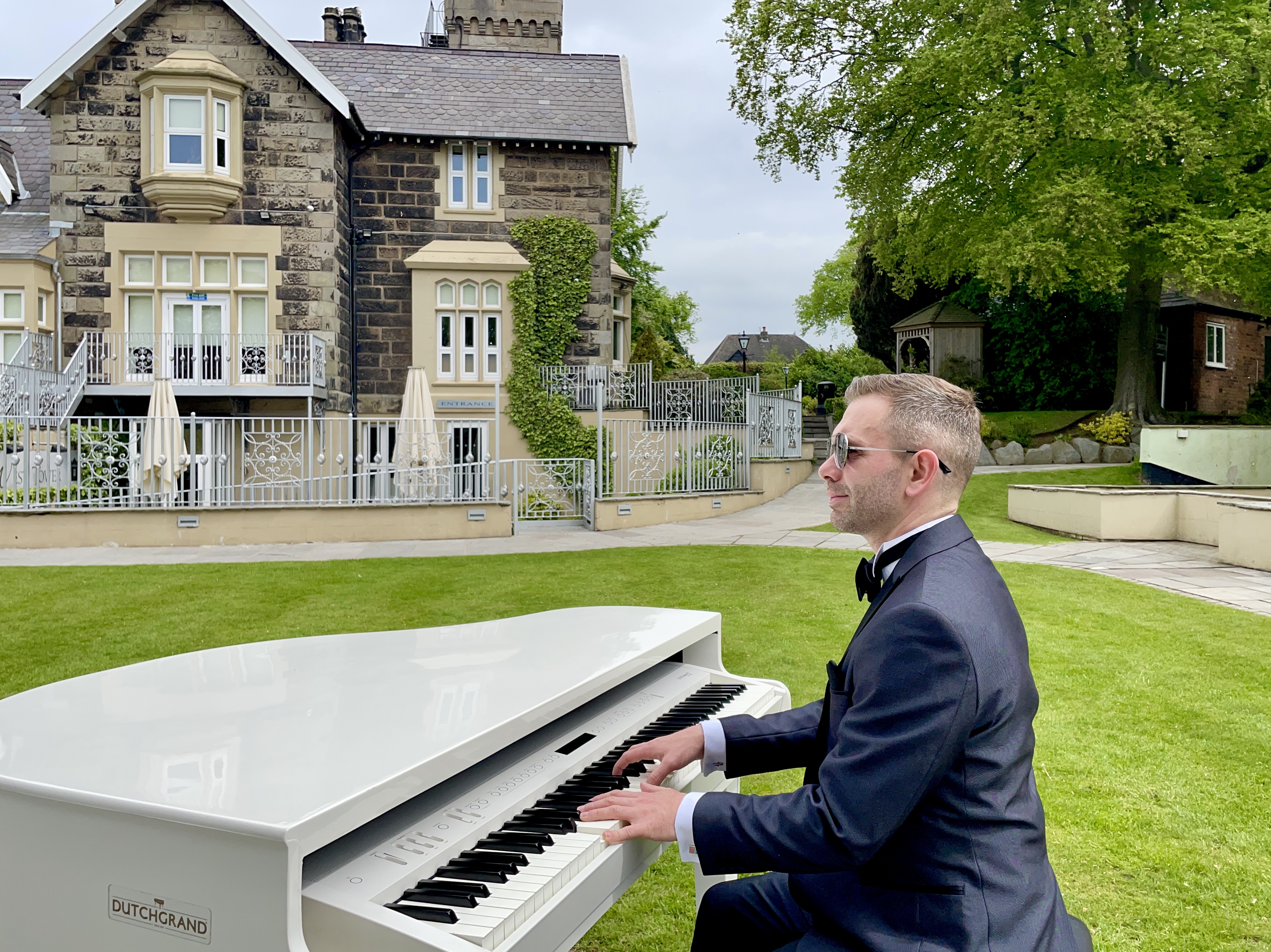 West Tower wedding pianist Craig Smith plays his white piano during a wedding ceremony